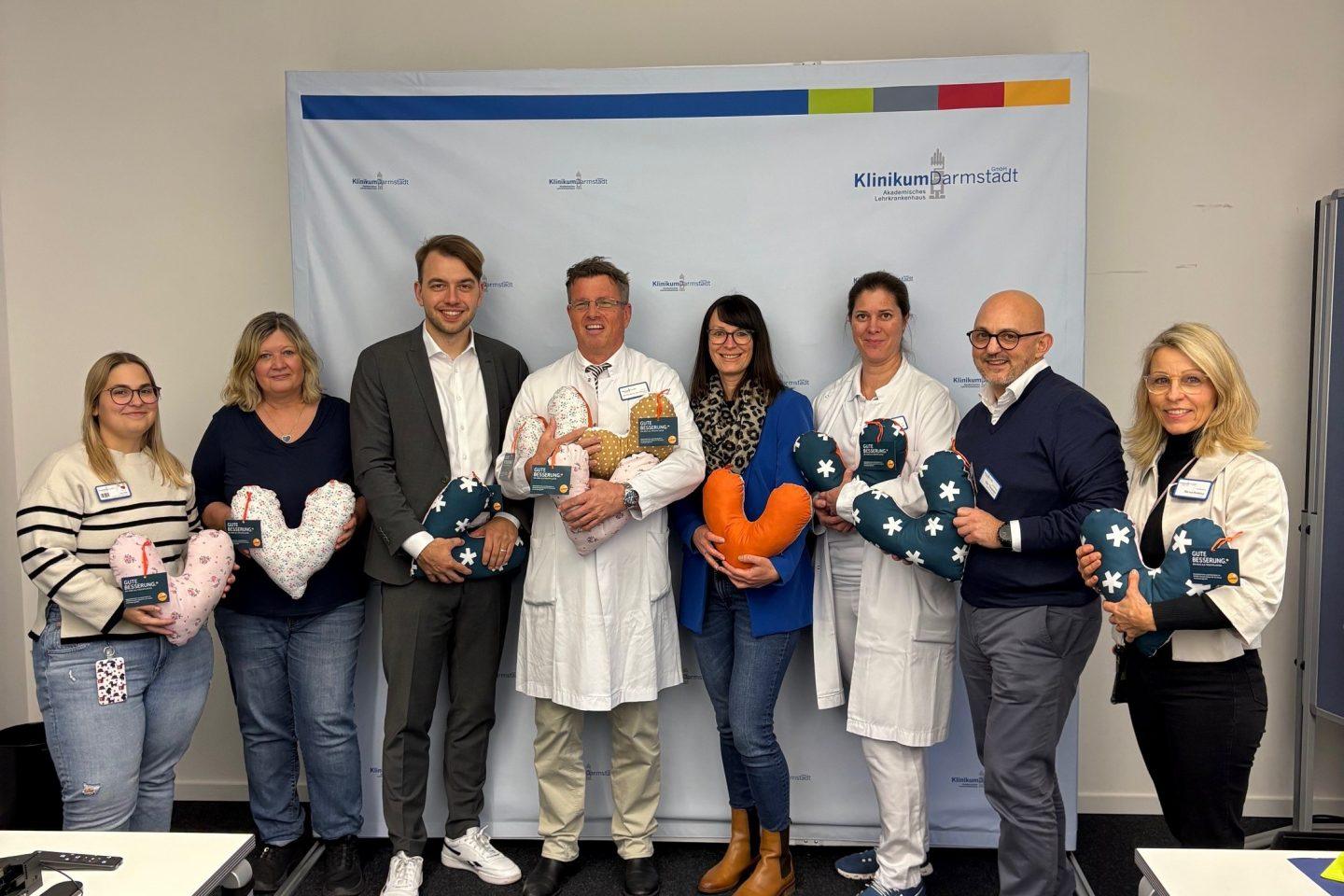 Gruppenfoto anlässlich der Übergabe der Herzkissen: (v.L.) Melanie Uhrig ( Krankenschwester auf der Station 11 D), Frau Brigitte Maurer (Breast Care Nurse ), Philipp Krämer (Leiter ENTEGA Unternehmenskommuniklation), PD. Dr. Sven Ackermann (Chefarzt/Klinikdirektor Frauenklinik), Julia Scheuch (ENTEGA), Katharina Rechel (leitende Oberärztin der Frauenklinik), Michelé Tarquinio ( pflegerischer Geschäftsführer ), Marion Rodehau (Hausdame) Foto: ENTEGA