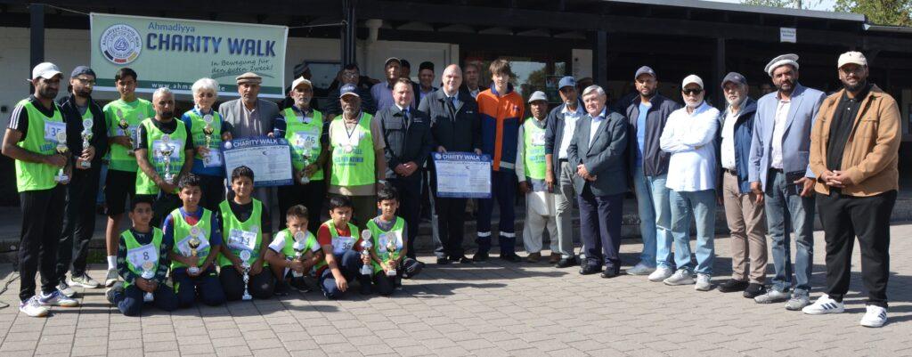 Gruppenbild mit u.a. den Siegern des Charity Walks, Wehrführer Goddelau Marcus Schramm, dem stellvertretenden Jugendwart Christopher Stein und Robin Stein von der Jugendwehr Goddelau (Bildmitte, v.li.) sowie dem Vorsitzenden der Ahmadiyya Muslim Gemeinde Riedstadt Ahmad Nadeem, Erstem Stadtrat Richard Kraft 5. und 6. v.re.) und Imam Awayes Malik (erster v.re.) Foto: Ahmadiyya Muslim Gemeinde Riedstadt